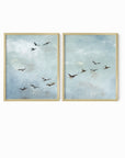 Set of 2 Flight - Flight I and II is a set of two abstract bird paintings featuring birds in flight against a softly textured cloudy sky in light blue, blue gray, cream, white, warm beige, brown, charcoal gray, and soft black; gold metal frame by NLS Design. Large neutral gallery wall art for living rooms, bedrooms, entryways, offices, and above the couch and above the bed. Horizontal Sizes: 8x10, 11x14, 16x20, 18x24, 24x36, 30x40, 40x60 inches. nlsdesignllc.com. Real art by a real artist - NO AI