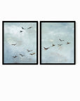 Set of 2 Flight - Flight I and II is a set of two abstract bird paintings featuring birds in flight against a softly textured cloudy sky in light blue, blue gray, cream, white, warm beige, brown, charcoal gray, and soft black; black oak frame by NLS Design. Large neutral gallery wall art for living rooms, bedrooms, entryways, offices, and above the couch and above the bed. Horizontal Sizes: 8x10, 11x14, 16x20, 18x24, 24x36, 30x40, 40x60 inches.  nlsdesignllc.com. Real art by a real artist - NO AI