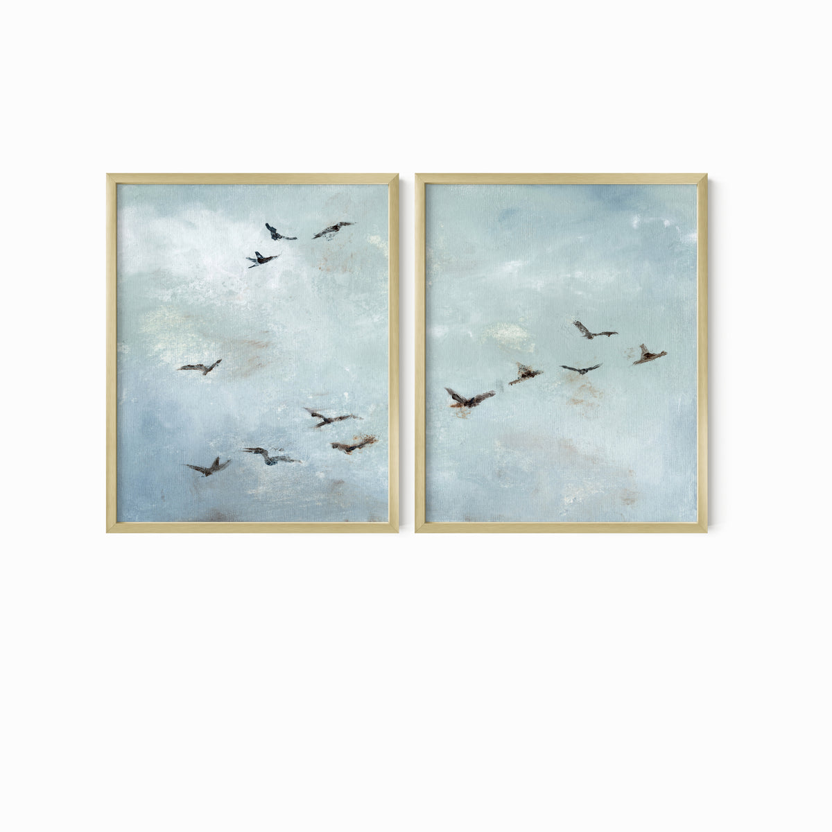 Set of 2 Flight - Flight I and II is a set of two abstract bird paintings featuring birds in flight against a softly textured cloudy sky in light blue, blue gray, cream, white, warm beige, brown, charcoal gray, and soft black; gold metal frame by NLS Design. Large neutral gallery wall art for living rooms, bedrooms, entryways, offices, and above the couch and above the bed. Horizontal Sizes: 8x10, 11x14, 16x20, 18x24, 24x36, 30x40, 40x60 inches.  nlsdesignllc.com. Real art by a real artist - NO AI
