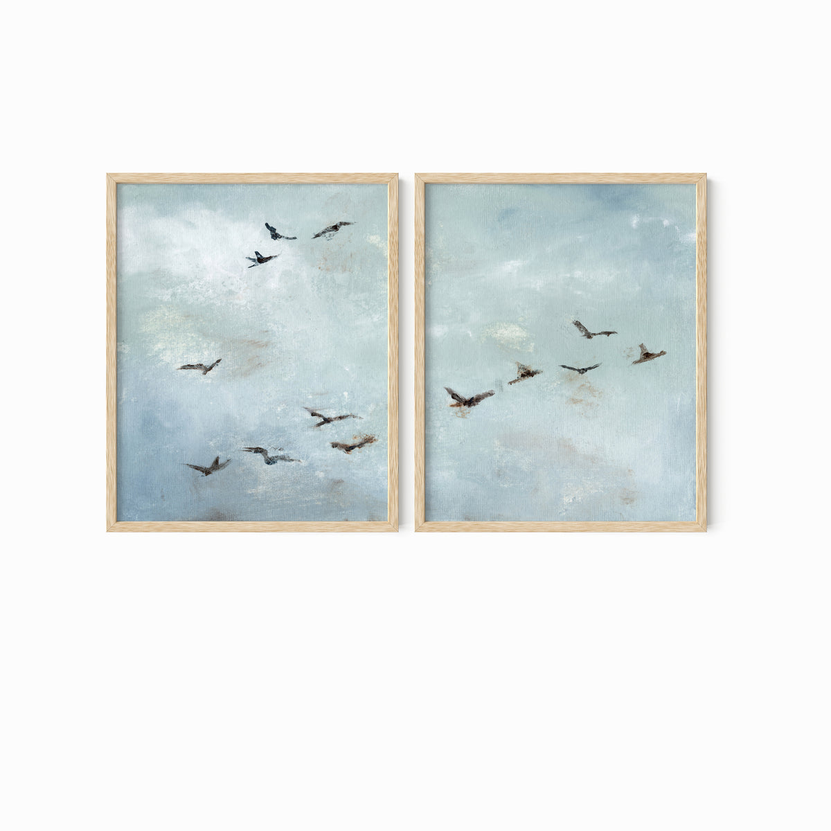 Set of 2 Flight - Flight I and II is a set of two abstract bird paintings featuring birds in flight against a softly textured cloudy sky in light blue, blue gray, cream, white, warm beige, brown, charcoal gray, and soft black; natural oak frame by NLS Design. Large neutral gallery wall art for living rooms, bedrooms, entryways, offices, and above the couch and above the bed. Horizontal Sizes: 8x10, 11x14, 16x20, 18x24, 24x36, 30x40, 40x60 inches.  nlsdesignllc.com. Real art by a real artist - NO AI