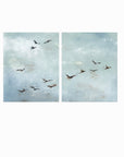 Set of 2 Flight - Flight I and II is a set of two abstract bird paintings featuring birds in flight against a softly textured cloudy sky in light blue, blue gray, cream, white, warm beige, brown, charcoal gray, and soft black; unframed by NLS Design. Large neutral gallery wall art for living rooms, bedrooms, entryways, offices, bathrooms, and above the couch and above the bed. Horizontal Sizes: 8x10, 11x14, 16x20, 18x24, 24x36, 30x40, 40x60 inches.  nlsdesignllc.com. Real art by a real artist - NO AI