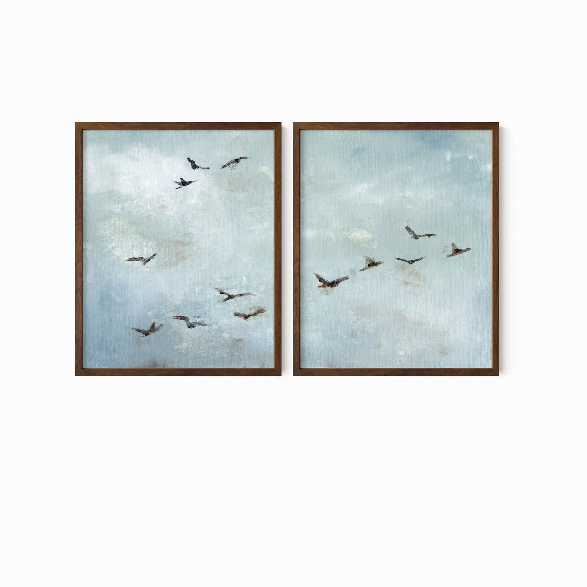 Set of 2 Flight - Flight I and II is a set of two abstract bird paintings featuring birds in flight against a softly textured cloudy sky in light blue, blue gray, cream, white, warm beige, brown, charcoal gray, and soft black; walnut oak frame by NLS Design. Large neutral gallery wall art for living rooms, bedrooms, entryways, offices, and above the couch and above the bed. Horizontal Sizes: 8x10, 11x14, 16x20, 18x24, 24x36, 30x40, 40x60 inches.  nlsdesignllc.com. Real art by a real artist - NO AI