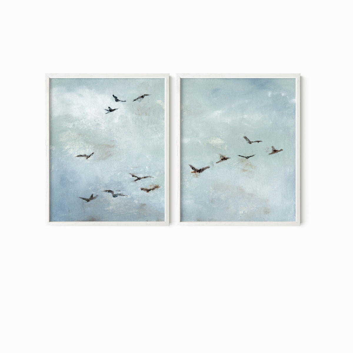 Set of 2 Flight - Flight I and II is a set of two abstract bird paintings featuring birds in flight against a softly textured cloudy sky in light blue, blue gray, cream, white, warm beige, brown, charcoal gray, and soft black; white oak frame by NLS Design. Large neutral gallery wall art for living rooms, bedrooms, entryways, offices, and above the couch and above the bed. Horizontal Sizes: 8x10, 11x14, 16x20, 18x24, 24x36, 30x40, 40x60 inches.  nlsdesignllc.com. Real art by a real artist - NO AI